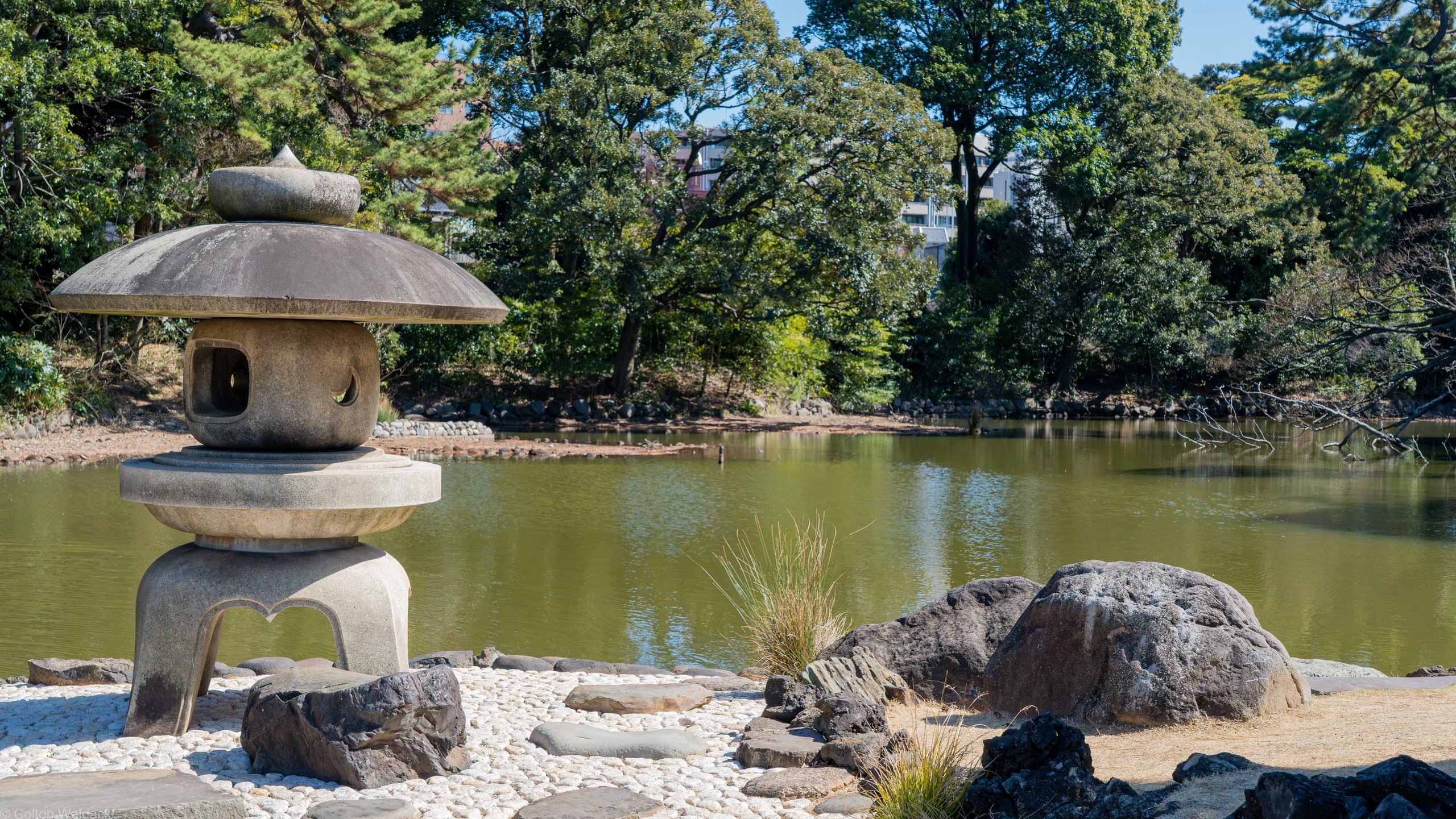 Stone lantern on a pebble islet in a Tokyo garden pond